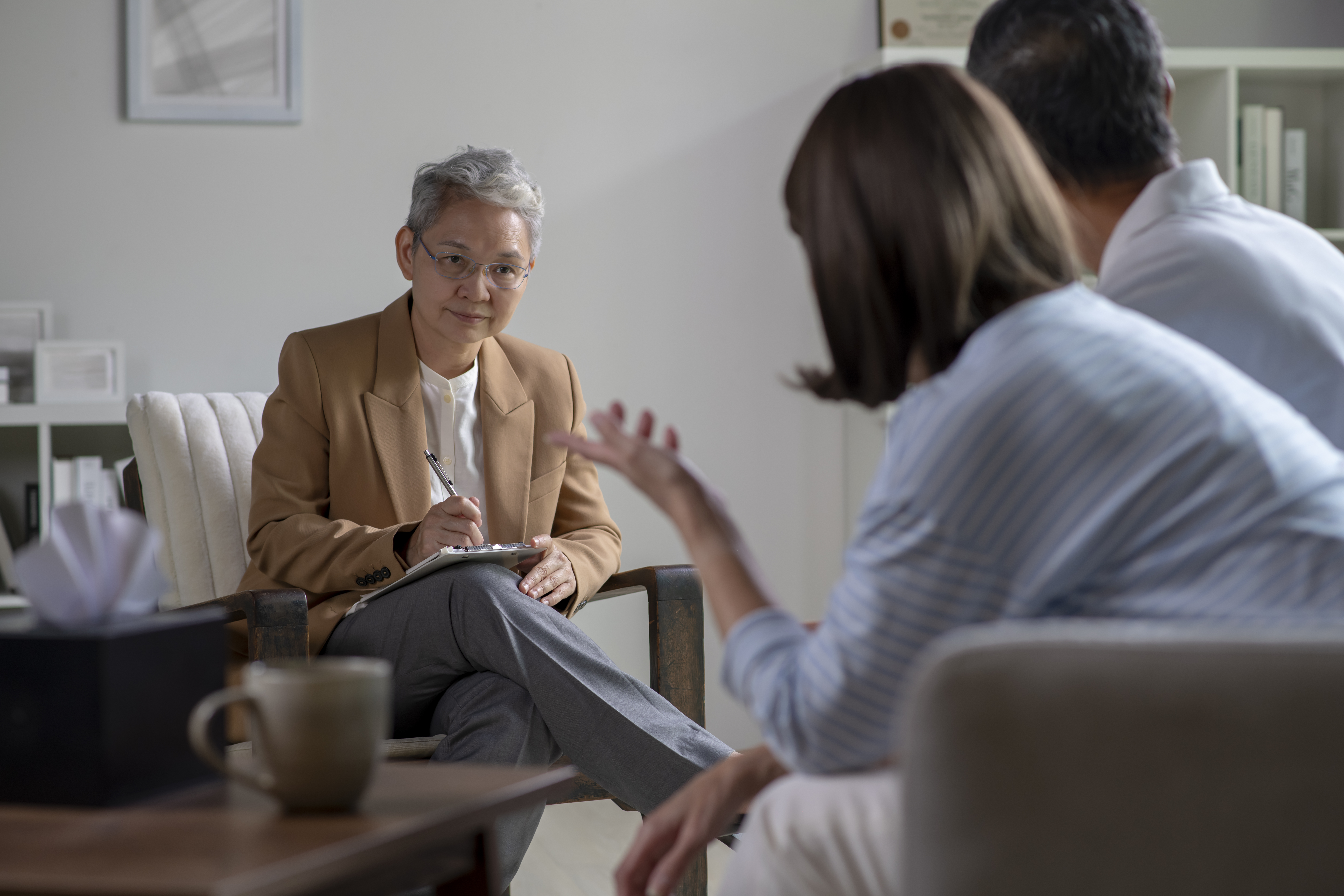 Mature Asian couple consulting couple relationship counselling to solve problems